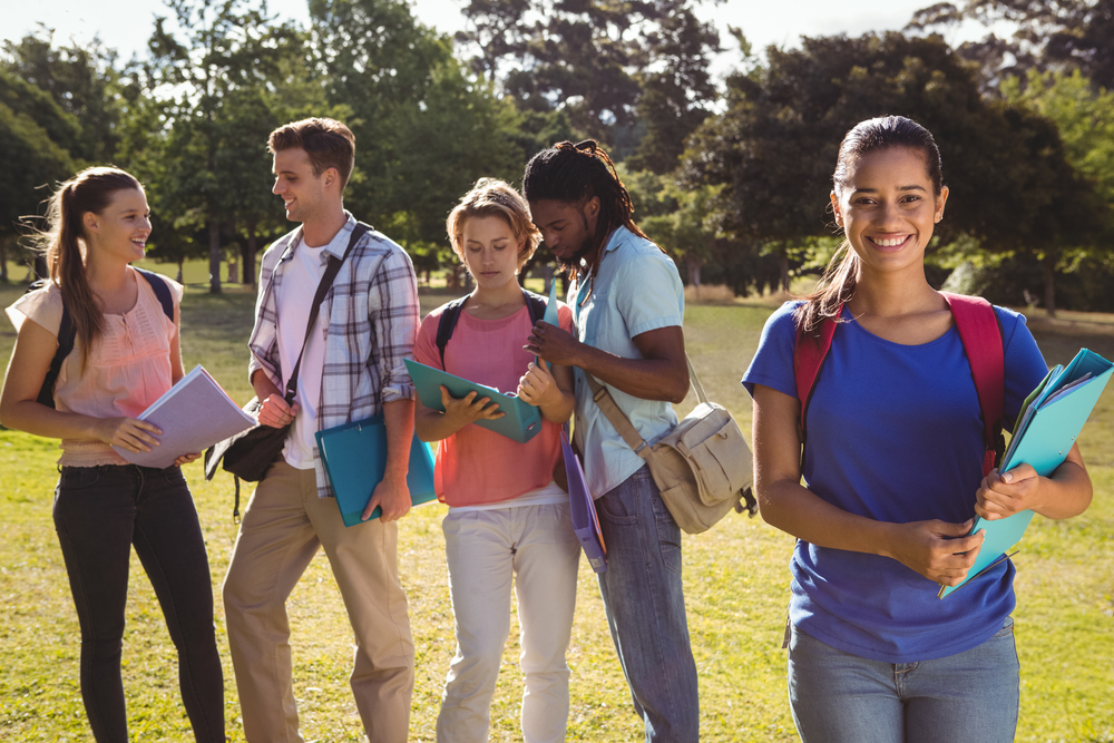 Happy students outside on campus on a sunny day